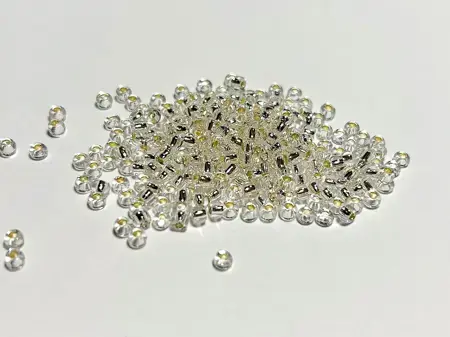 Preciosa rokajl 11/0 – průhledná se stříbrným průtahem (78102), 10 g