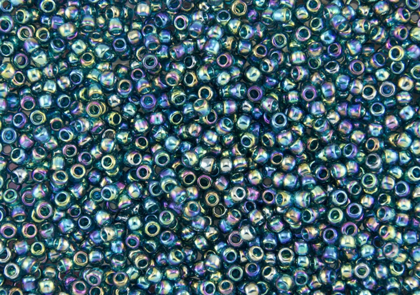 Rokajlové korálky Toho  - Round 15/0 : Transparent-Rainbow Teal TR-15-167BD - fotografie 1